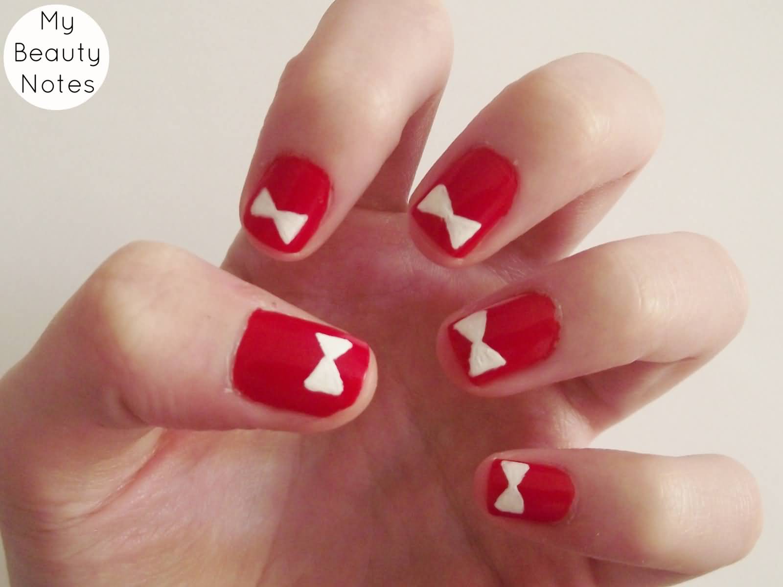 Red Nails With White Acrylic Bow Nail Art