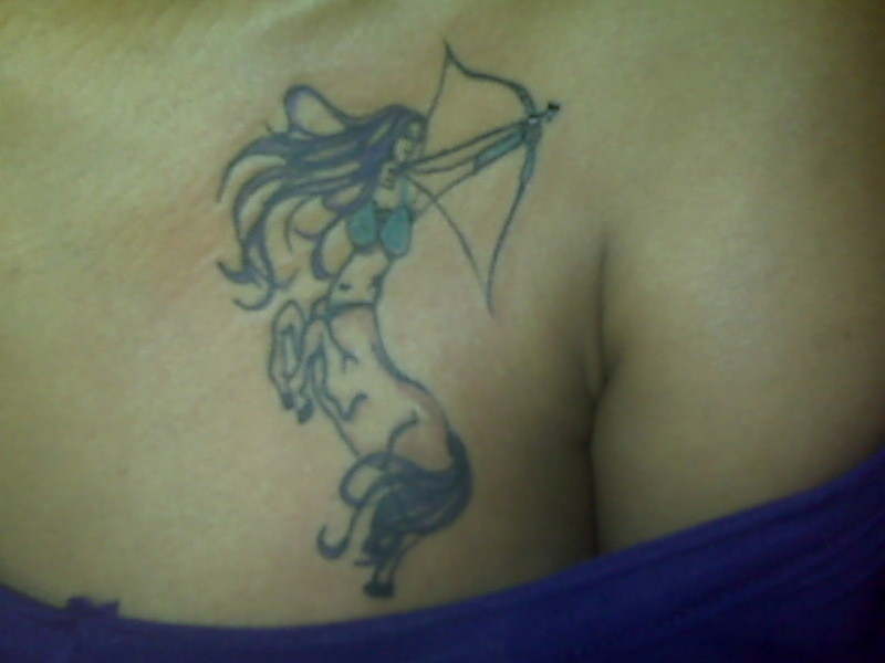 Sagittarius Female With Bow And Arrow Tattoo On Chest