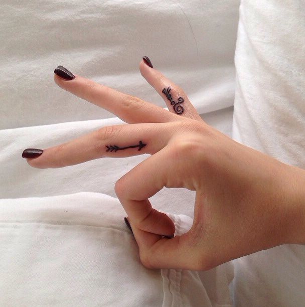 Small Black Color Arrow With Name Tattoo On Fingers