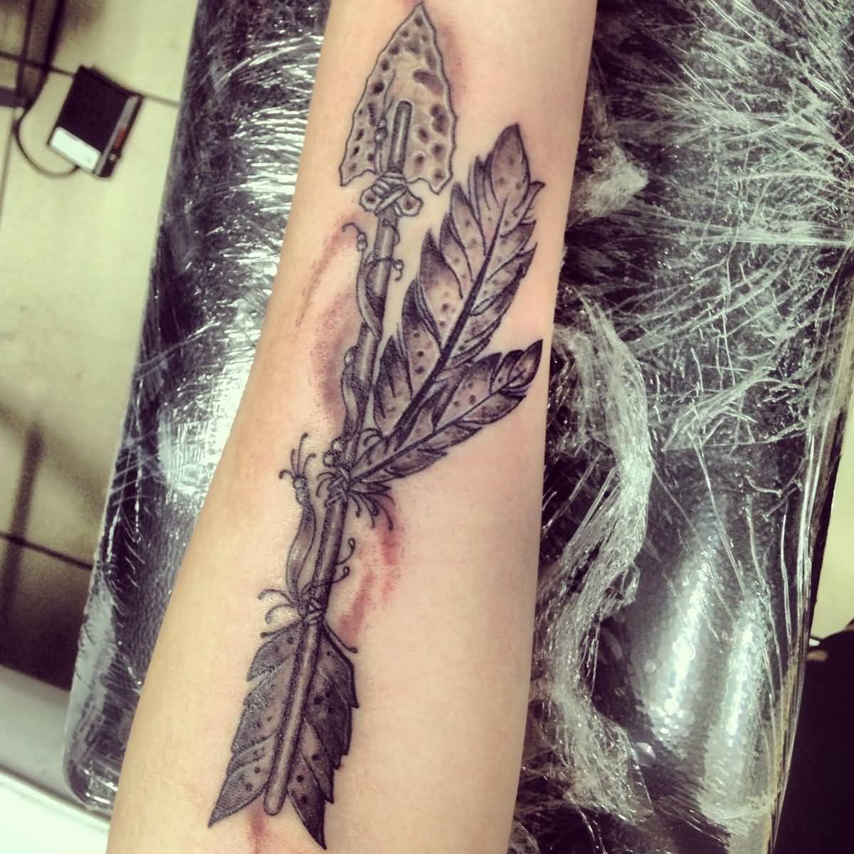Stunning Arrow With Feather Tattoo On Forearm