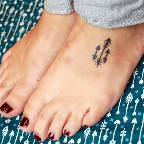 Three Amazing Tiny Arrows In Black Ink Tattoo On Foot