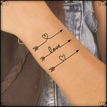 Three Arrows With Love And Heart Tattoos On Wrist