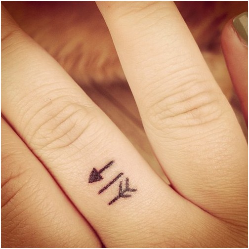 Tiny Arrow Tattoo On Finger