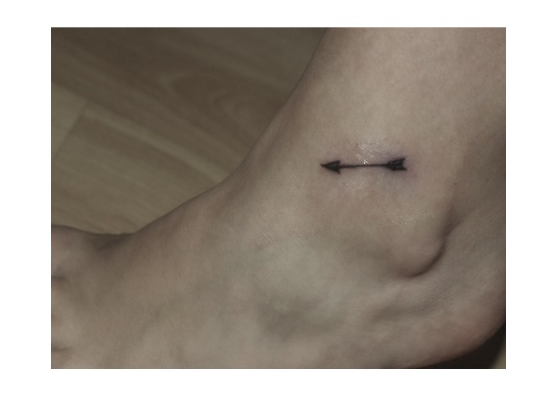 Tiny Black Arrow Tattoo On Ankle