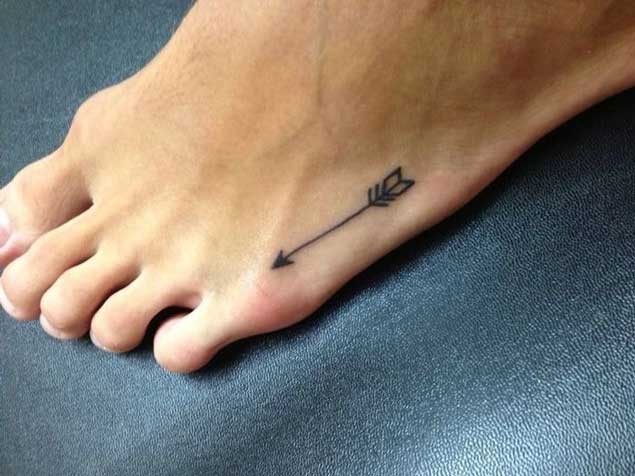 Tiny Black Arrow Tattoo On Foot