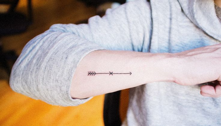 Tiny Black Arrow Tattoo On Forearm
