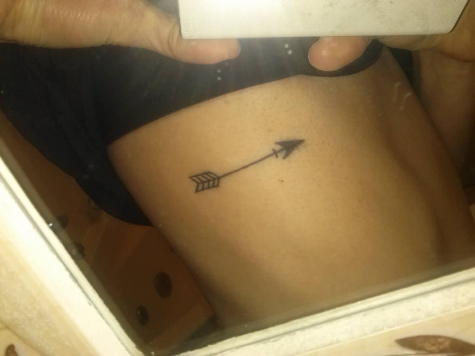 Tiny Black Arrow Tattoo On Rib For Girl