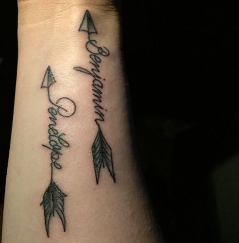 Two Arrows With Name Tattoo On Wrist