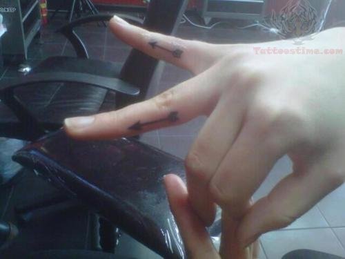 Two Black Arrows Tattoos On Fingers