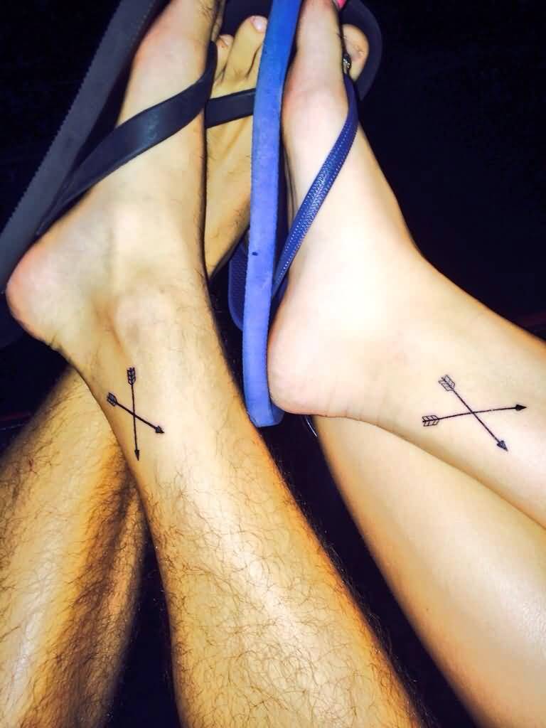 Two Small Crossed Arrows Tattoos On Two Foots