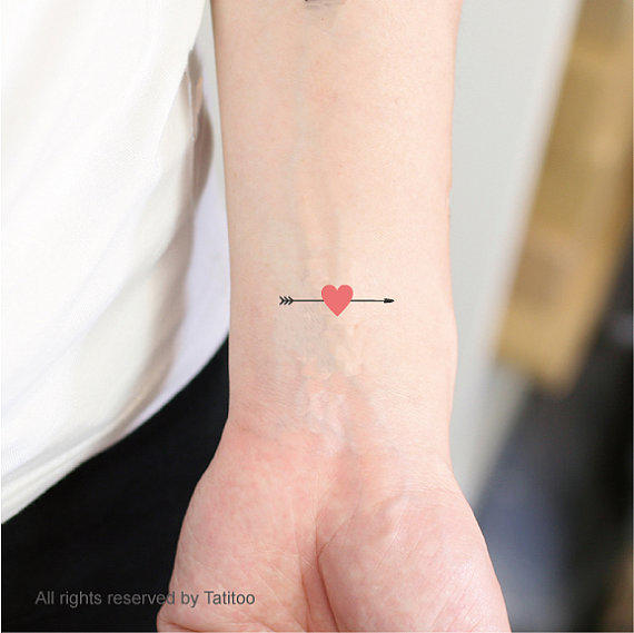 Very Tiny Arrow With Heart Shape Tattoo On Wrist