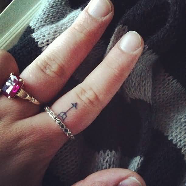 Very Tiny Black Ink Arrow Tattoo On Finger