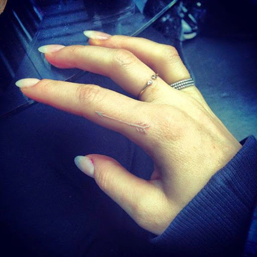 White Ink Arrow Tattoo On Finger