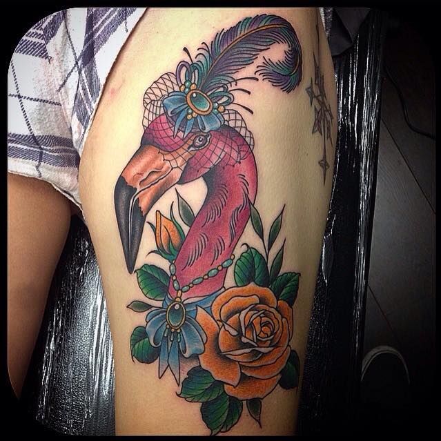 Adorable Flamingo Wearing Feather Hat And Necklace With Yellow Rose Tattoo On Thigh