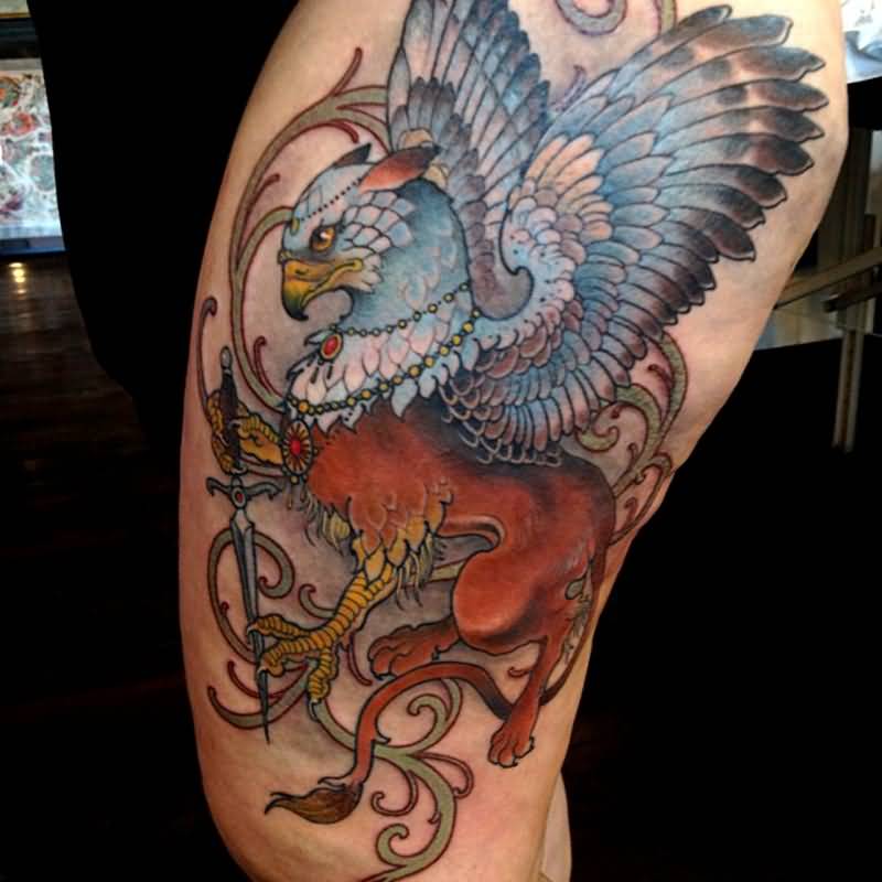 Awesome Colorful Griffin With Sword Tattoo On Thigh
