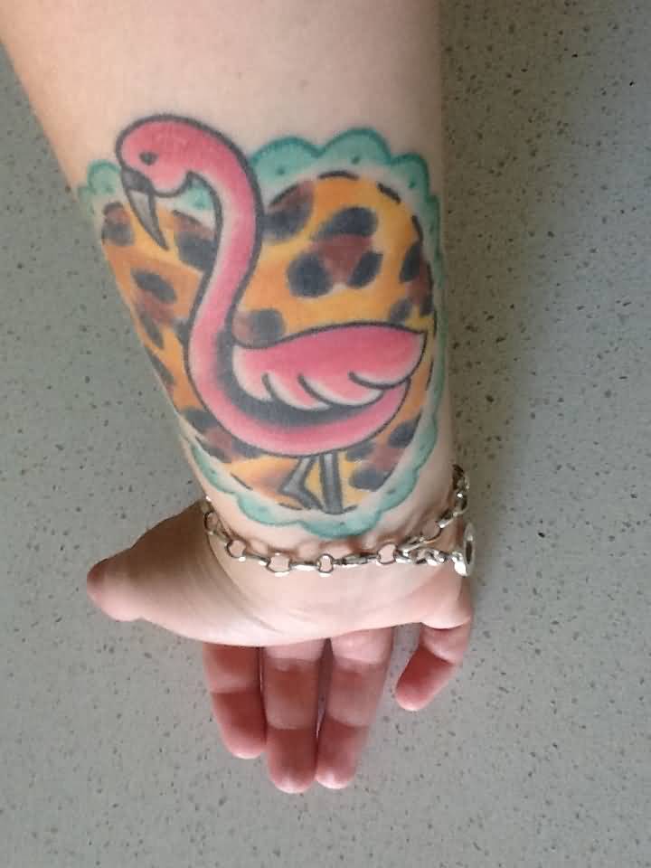 Baby Flamingo In Heart Shape Frame Tattoo On Wrist