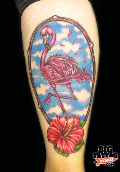 Beautiful Flamingo In Mirror With Red Flower Tattoo On Forearm