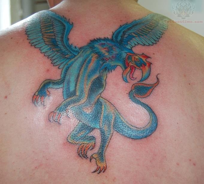 Blue Color Griffin Tattoo On Upper Back
