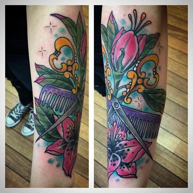Colorful Comb With Scissor And Red Flowers Tattoo On Forearm