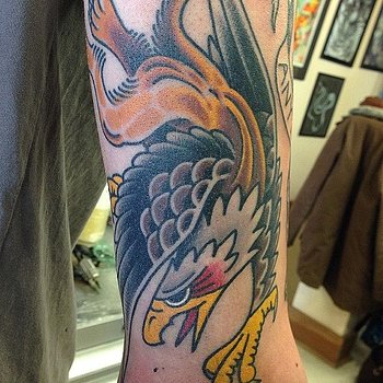 Colorful Flying Griffin Tattoo On Sleeve