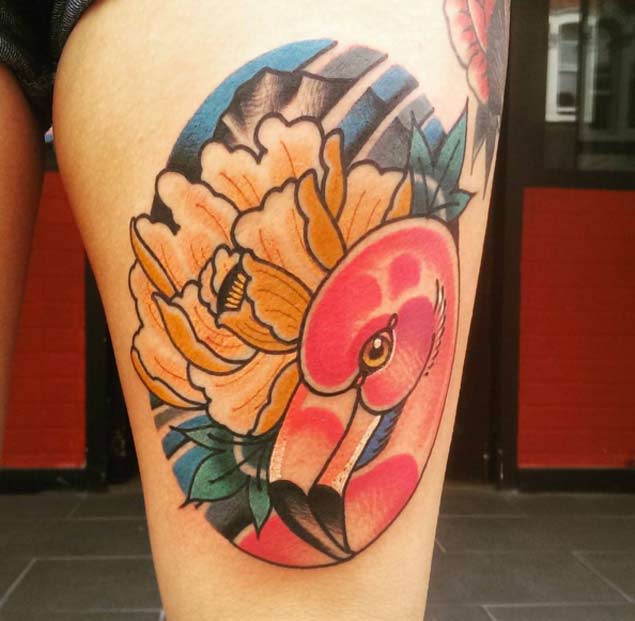 Flawless Flamingo With Flower In Circle Tattoo On Thigh