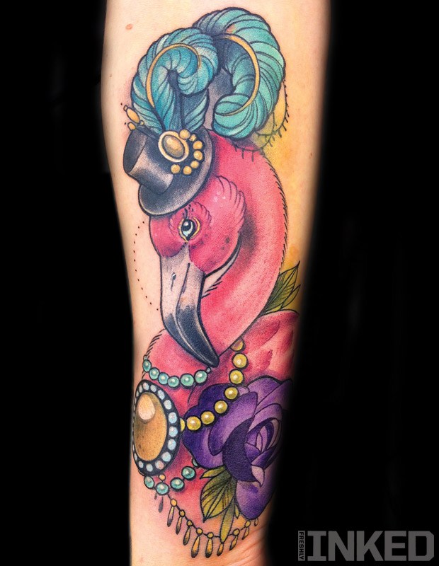 Funny Flamingo Wearing Hat With Feathers And Necklace Tattoo On Forearm