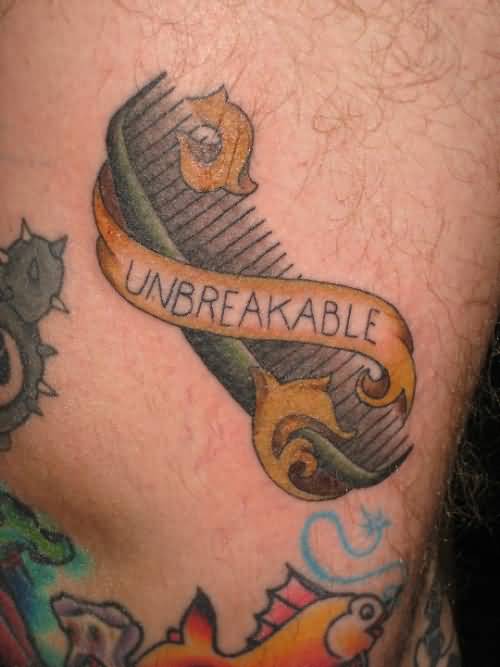 Gorgeous Unbreakable Banner And Comb Tattoo