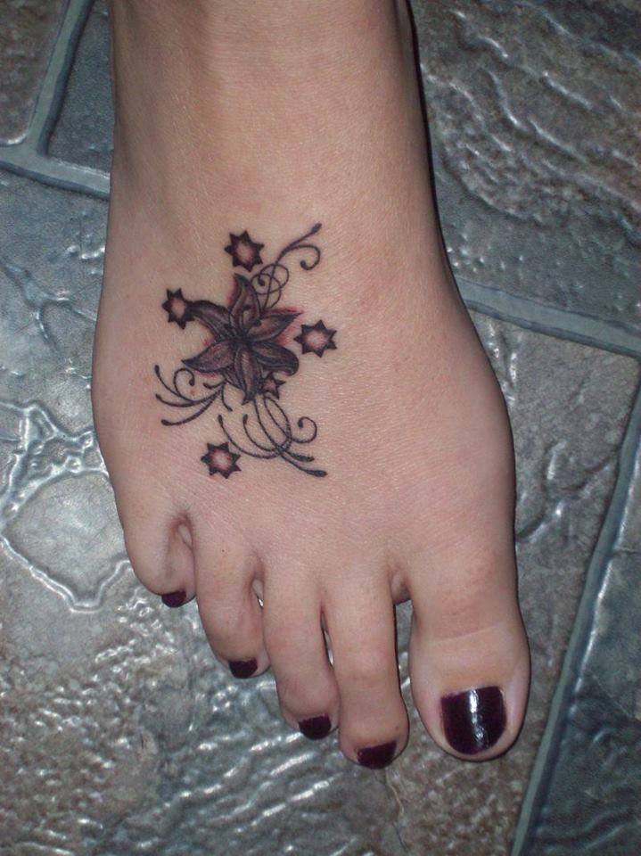 Grey Flower And Stars Tattoo On Girl Right Foot