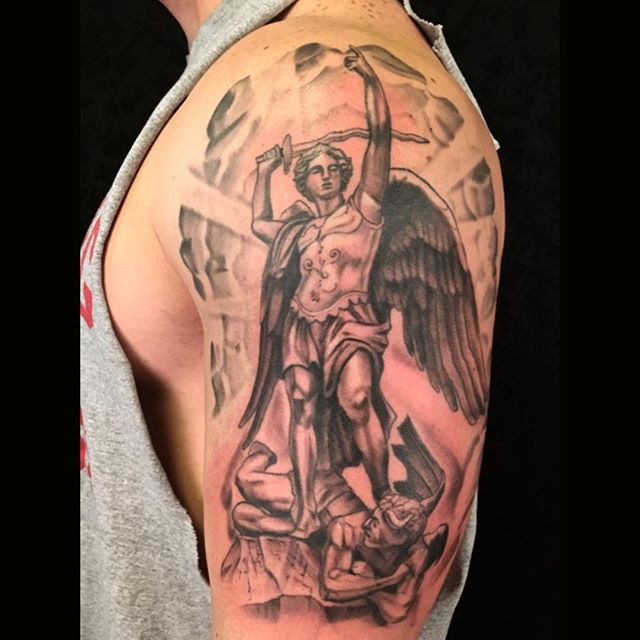 Grey Ink Archangel Tattoo On Man Left Half Sleeve