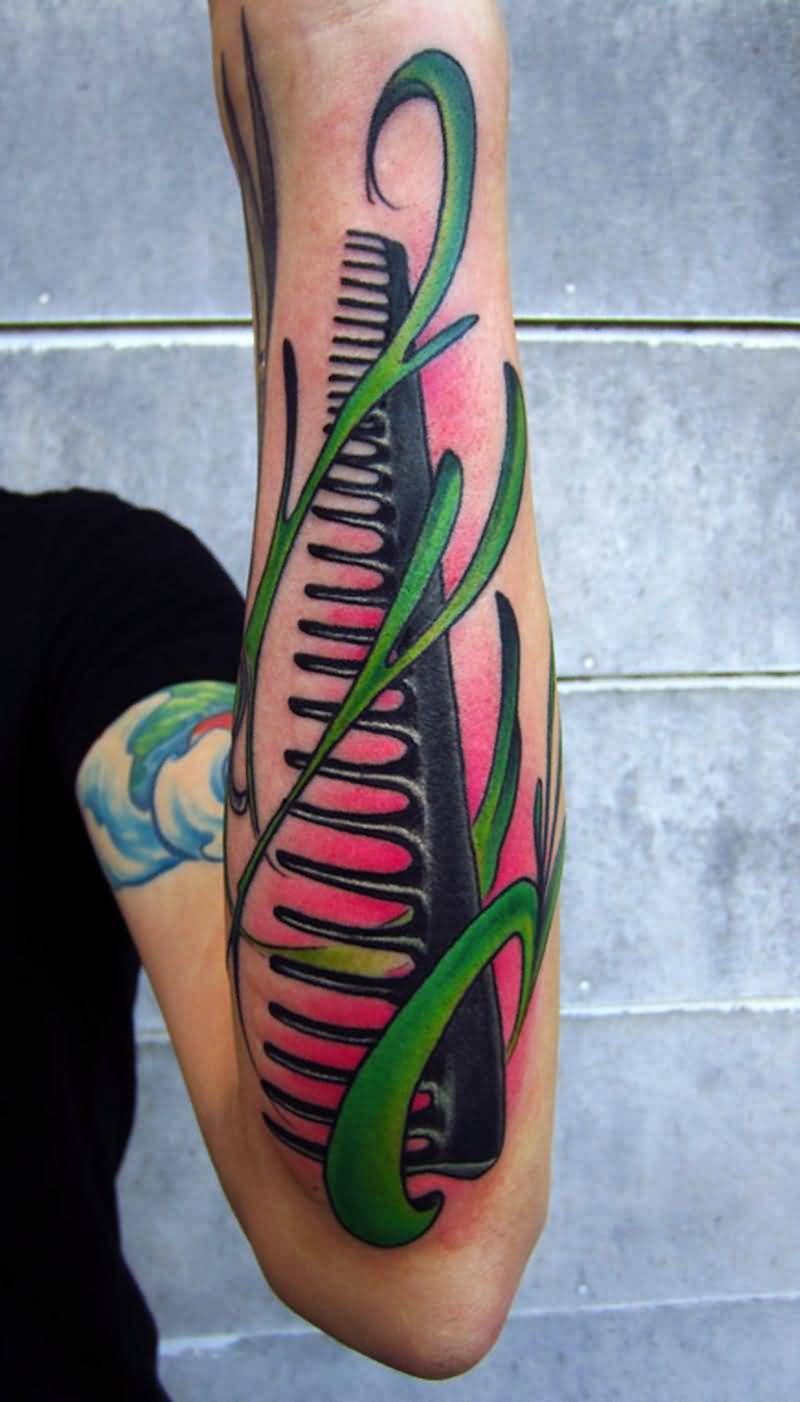 Large Comb With Green Filigree Tattoo On Forearm