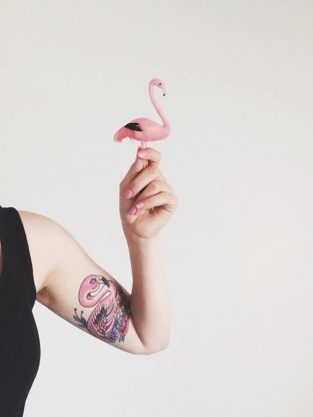 Nice Flamingo With Flowers Tattoo On Bicep