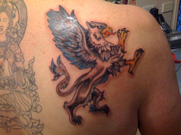 Nice Traditional Griffin Tattoo On Right Side Of Back