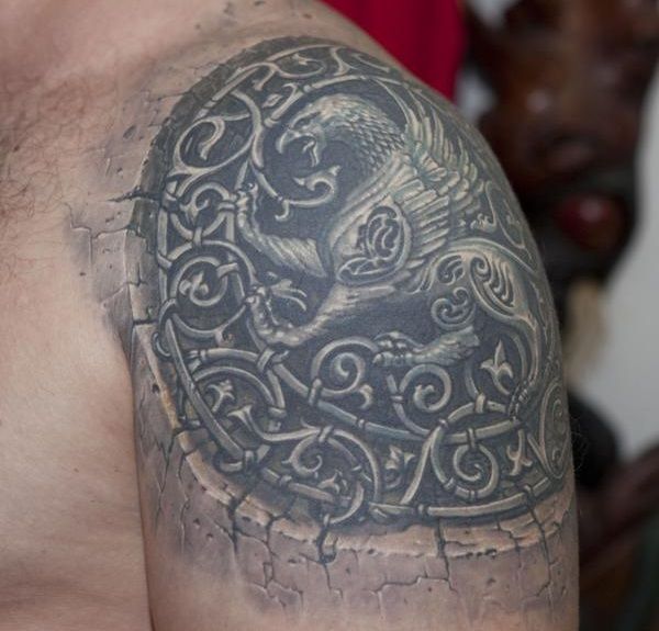 Outstanding Roaring Griffin In Old Style Circle Tattoo On Shoulder