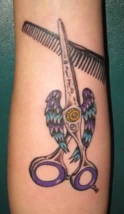 Scissor With Angel Wings And Comb Tattoo On Forearm