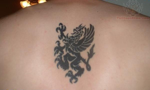 Small Tribal Griffin Tattoo On Upper Back