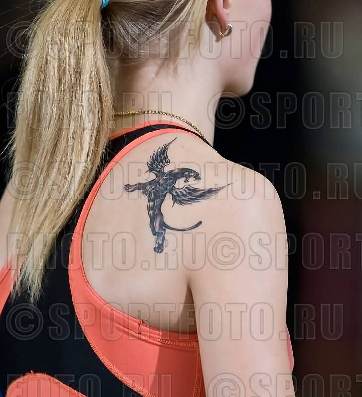 Tiny Dark Colored Roaring Griffin Tattoo On Back Shoulder