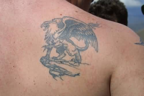 Tiny Griffin Tattoo On Back Shoulder
