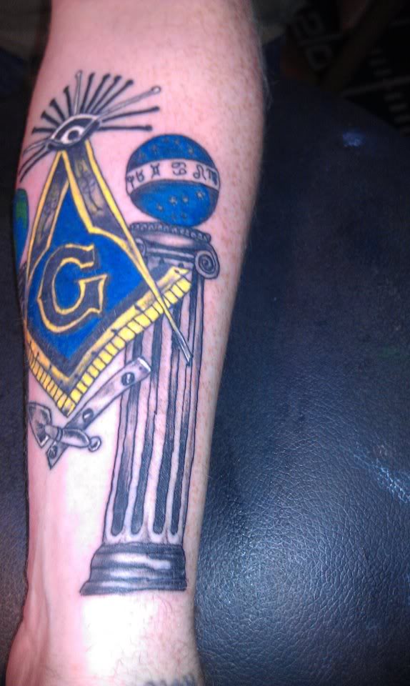 Blue Ink Masonic Tattoo On Left Forearm