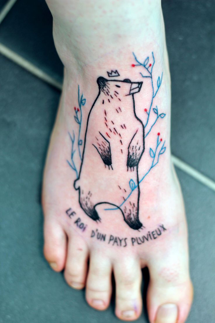 Cute Polar Bear Wearing Crown And Lettering Tattoo On Foot
