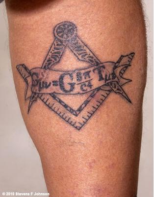 Grey Ink Masonic Tattoo On Leg