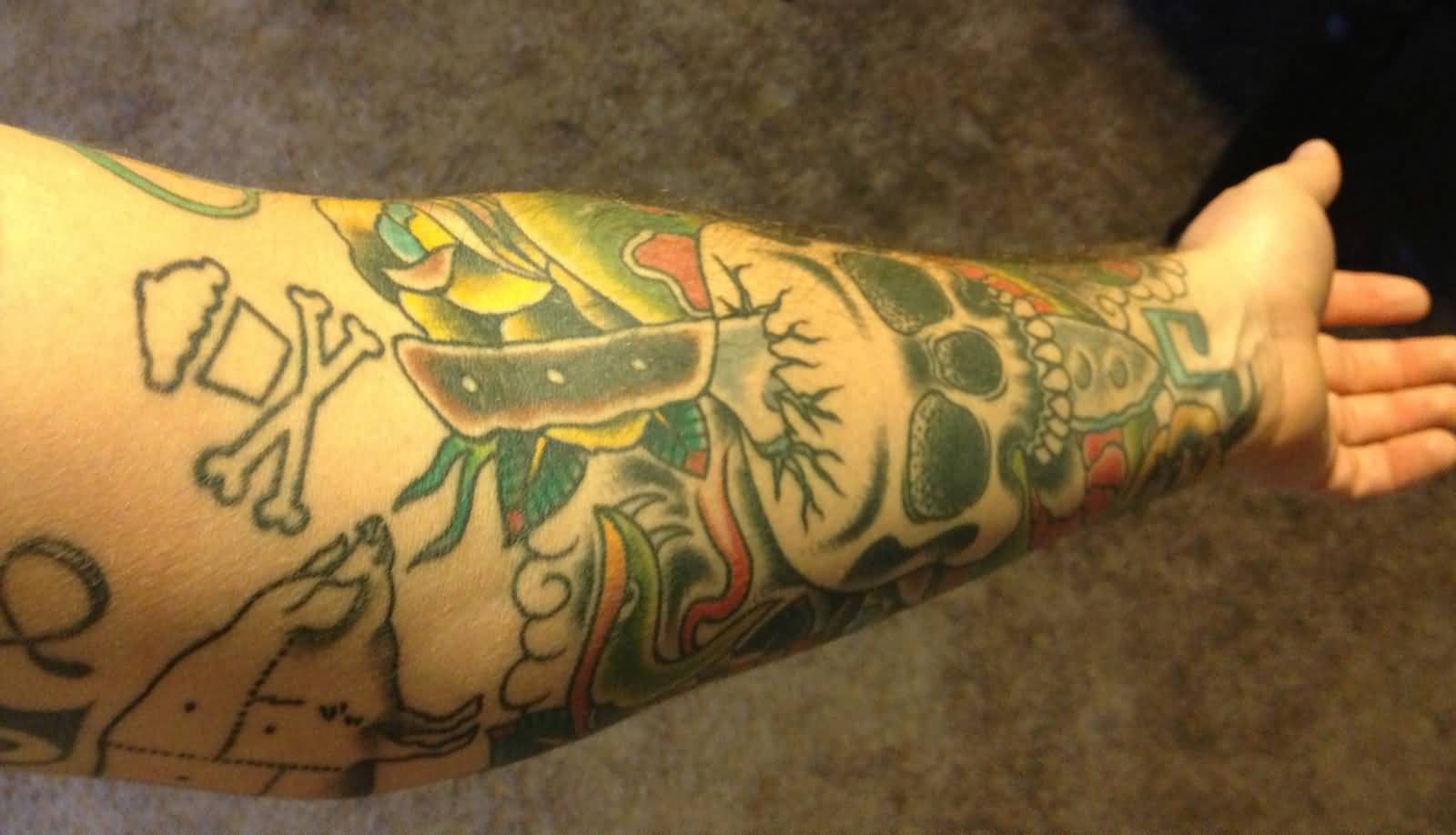 Awesome Chef Knife Ripped Skull And Other Stuff Tattoo On Forearm