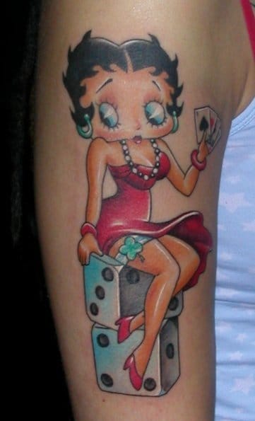 Betty Boop Sitting On Dice Stack With Cards In Hands Tattoo