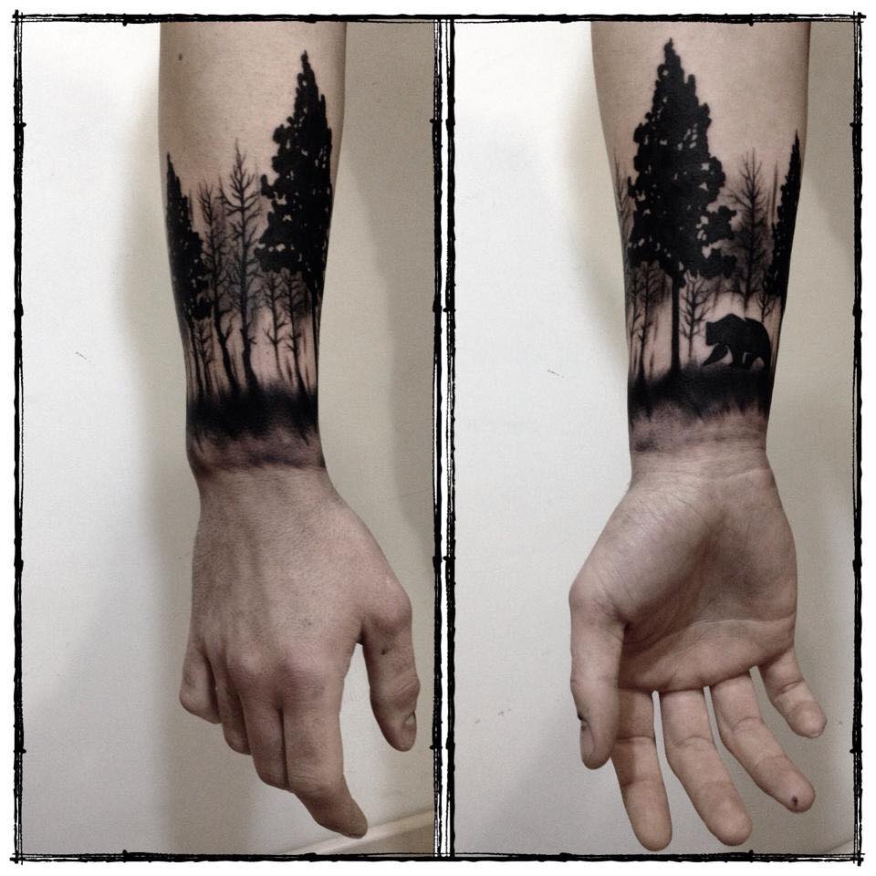 Black And Grey Bear In Forest Tattoo On Forearm