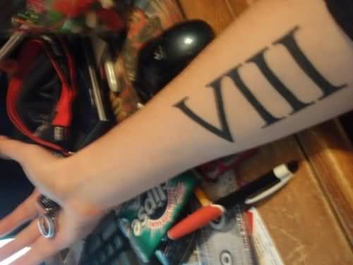 Black Color Roman Numerals Eight Tattoo On Forearm