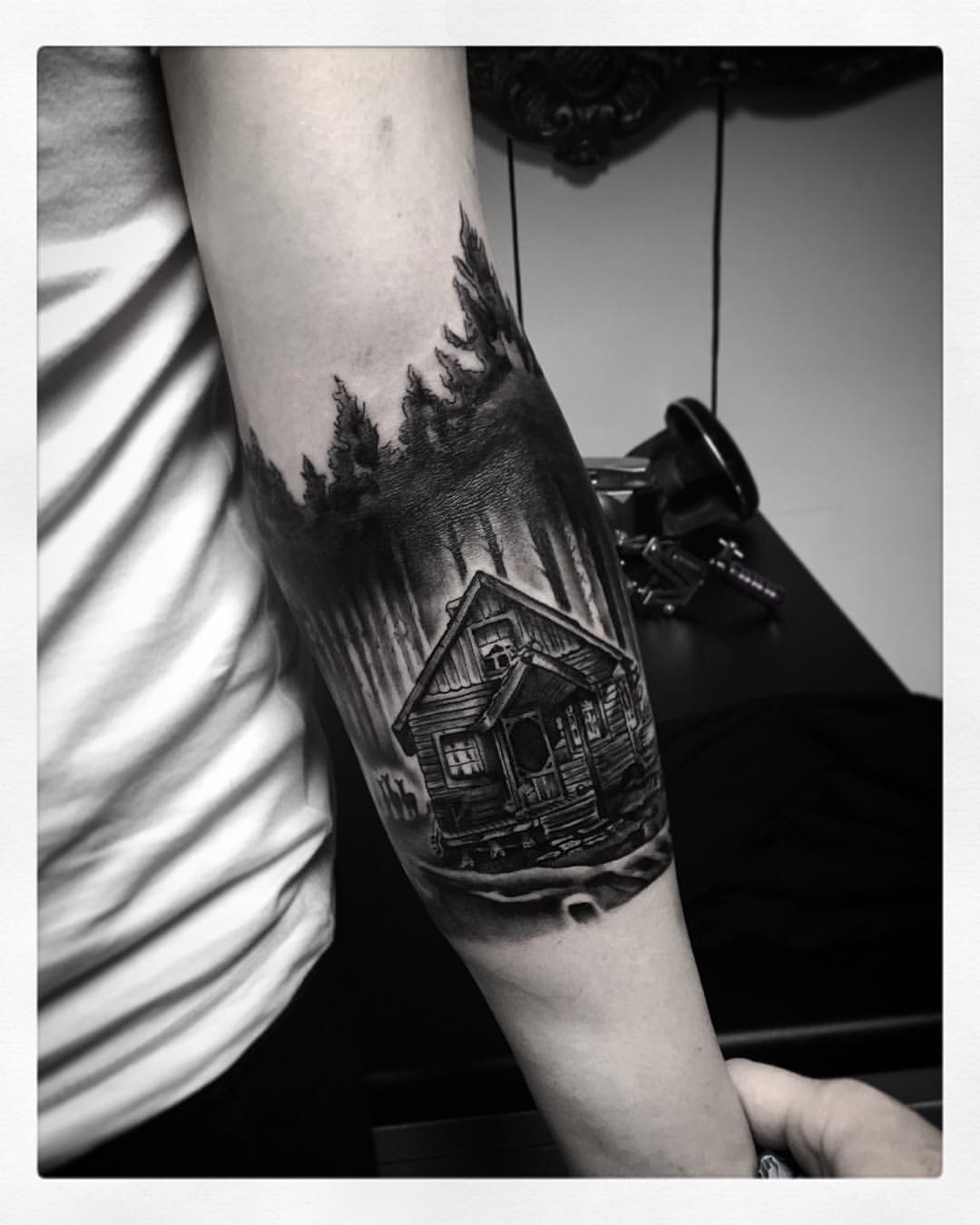 Black Ink Wooden House In Forest Tattoo On Arm Sleeve