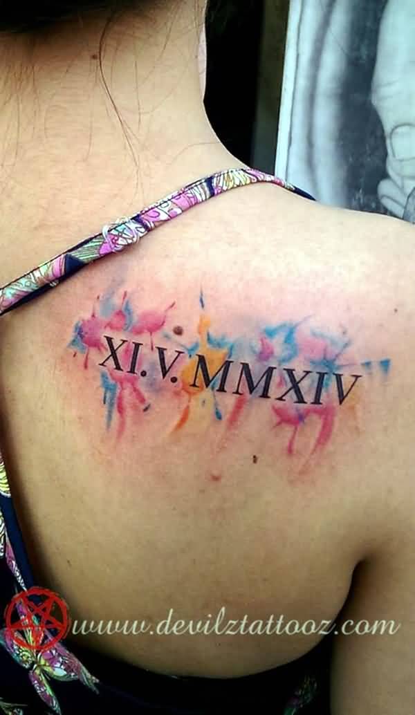 Black Roman Numerals With Colorful Watercolor Background Tattoo On Back Right Shoulder