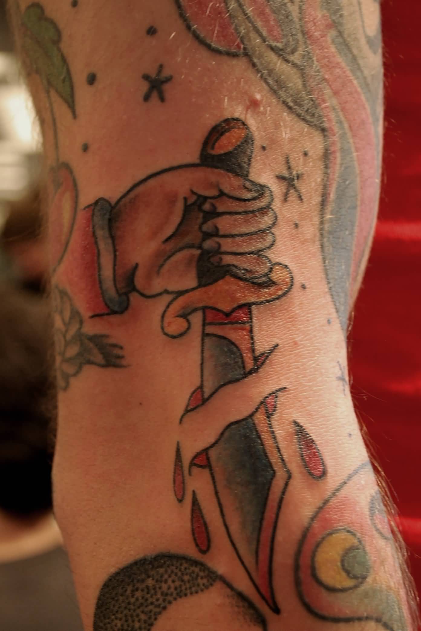 Chef Hand Holding Knife Ripped Skin Tattoo