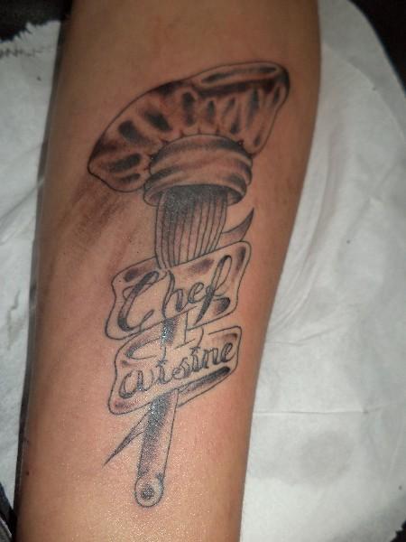 Chef Hat With Egg Beater And Chef Cuisine On Banner Tattoo On Arm Sleeve