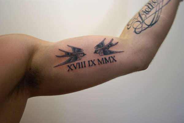 Cool Roman Numeral With Birds Tattoo On Bicep For Man