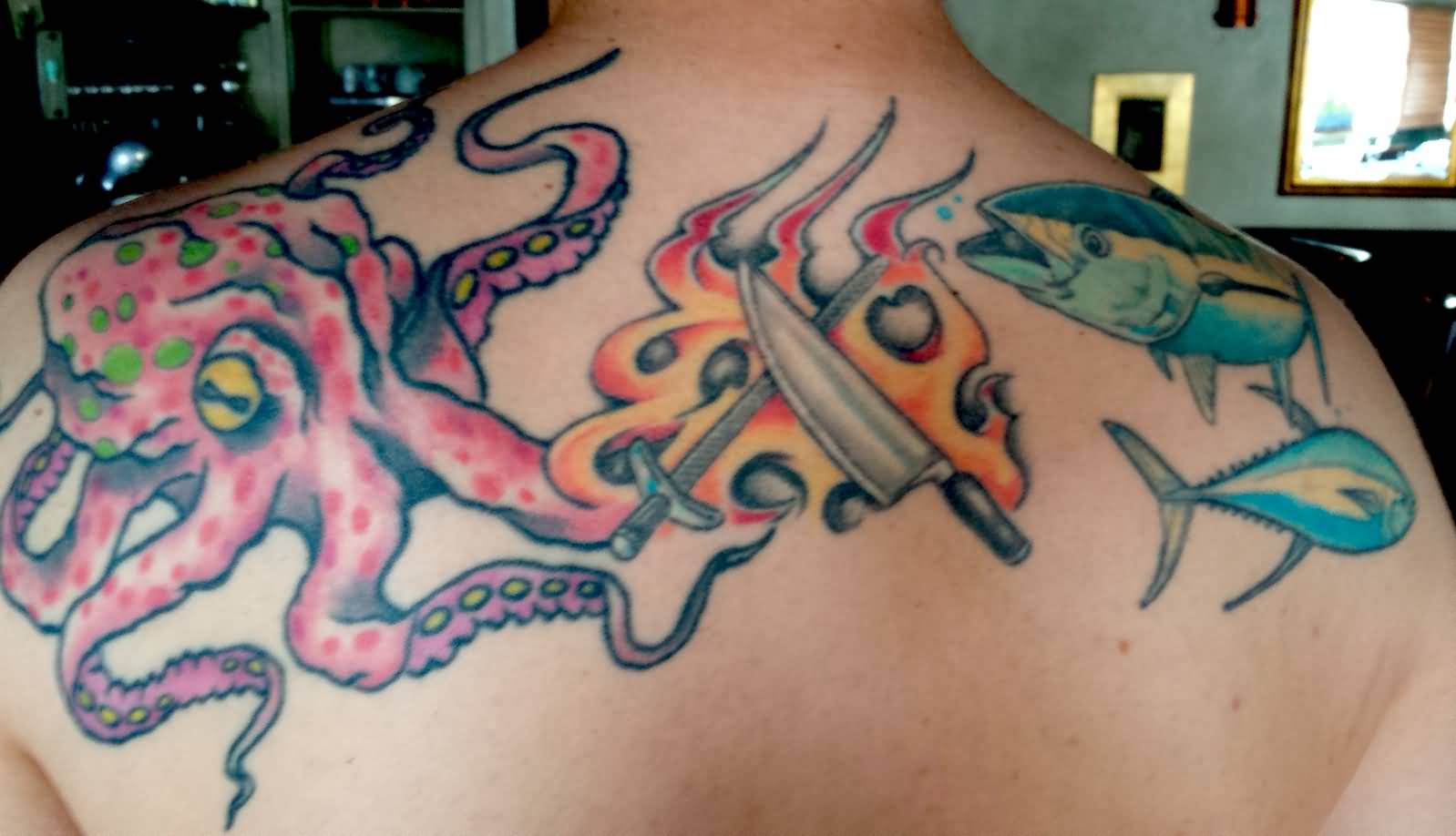 Cross Chef Knife And Sword With Octopus And Fishes Tattoo On Upper Back